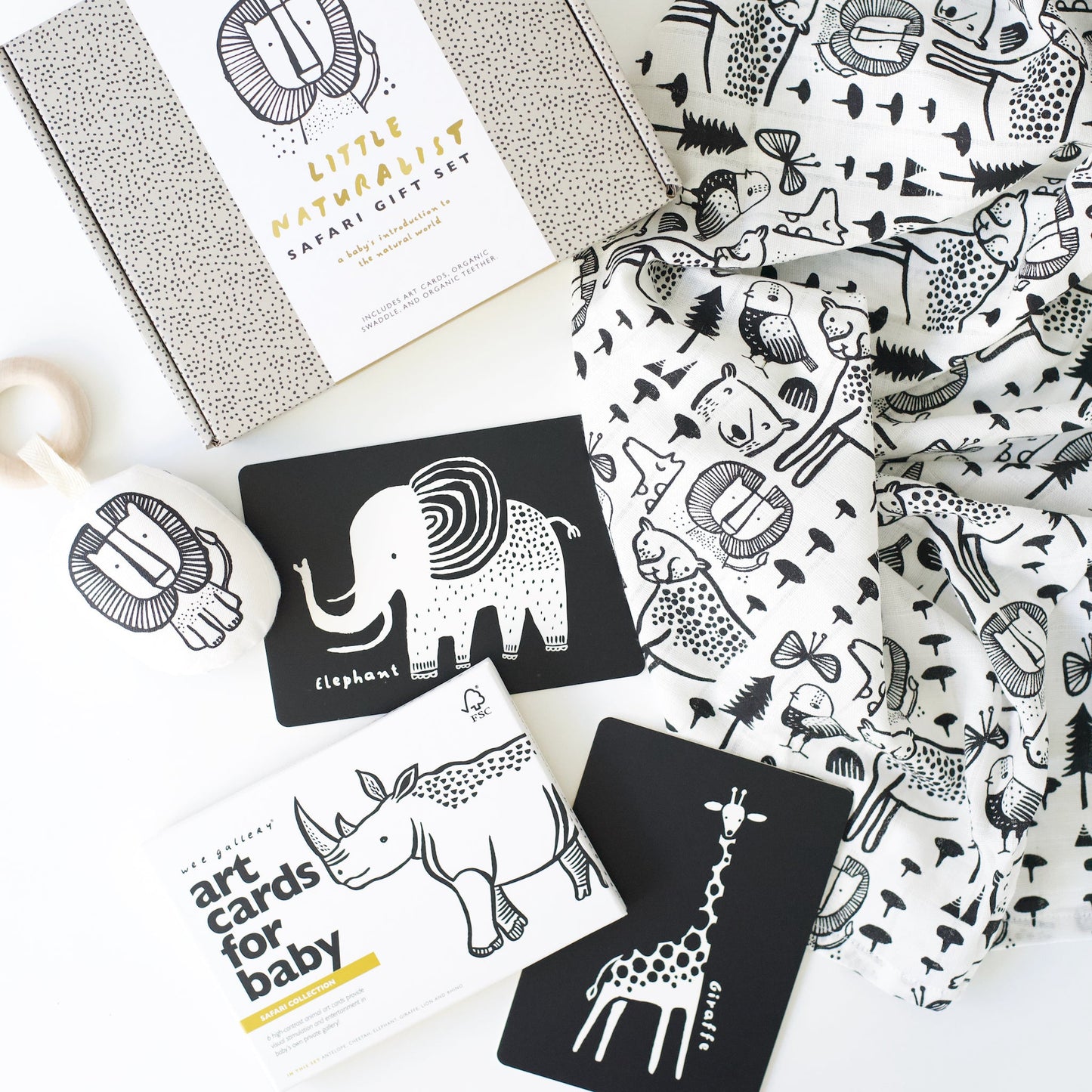 Collection of art cards with animal illustrations and a patterned fabric on a white surface.