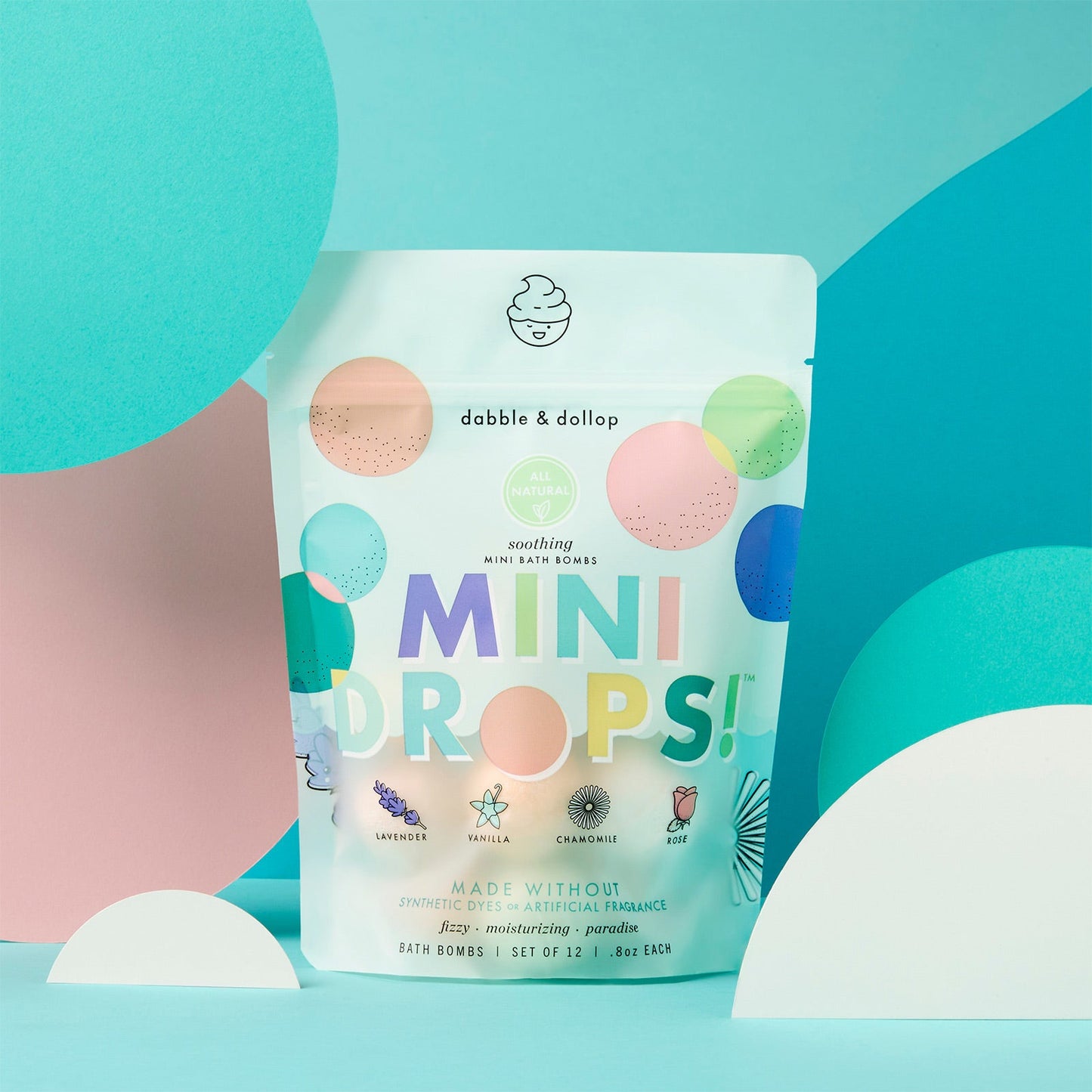 Dabble & Dollop Mini Drops packaging on a colorful geometric background