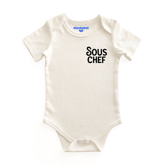 White baby onesie with 'Sous Chef' text on a white background