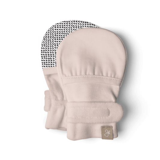 Beige baby mittens with a brand label on a transparent background