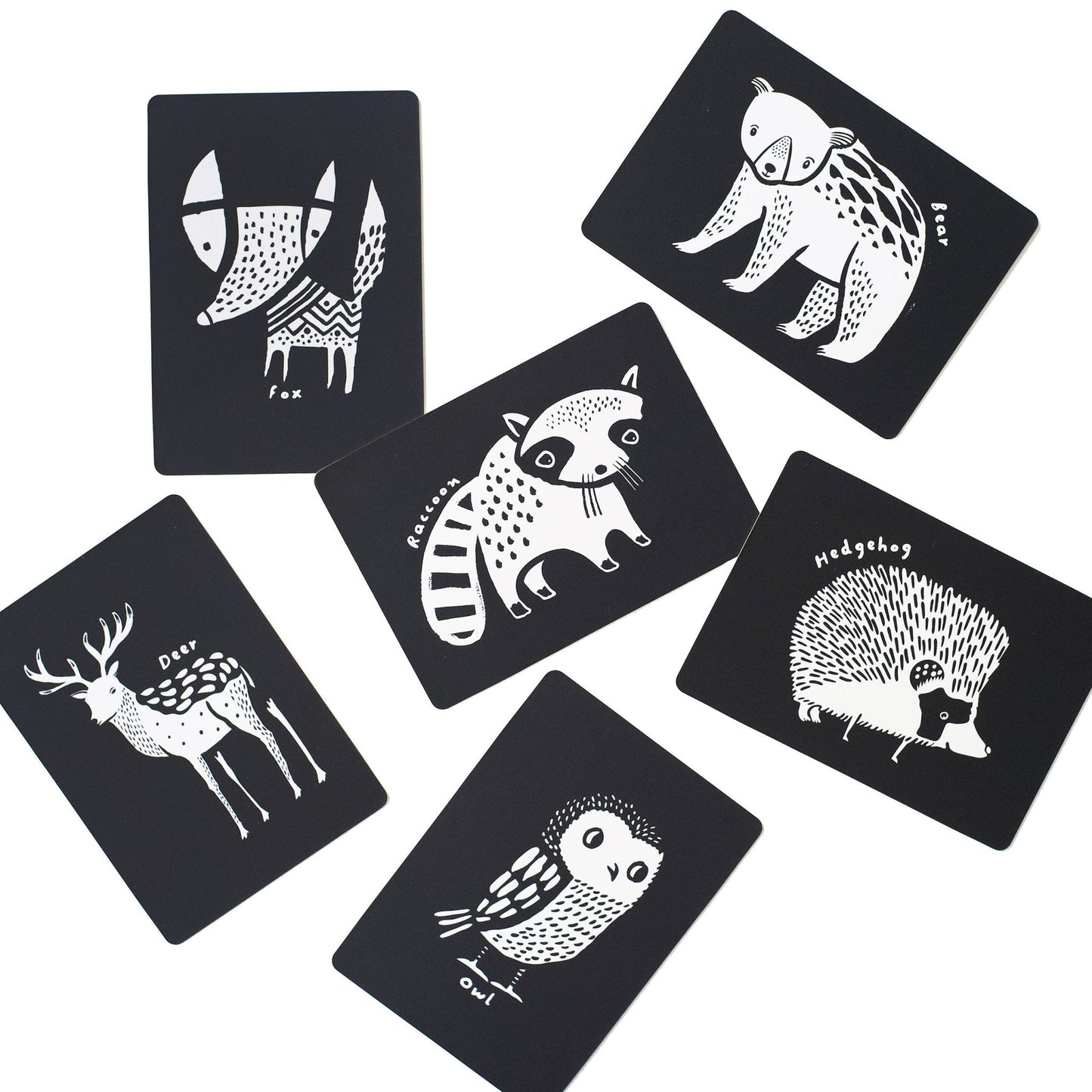 Set of six black cards with white animal illustrations on a white background