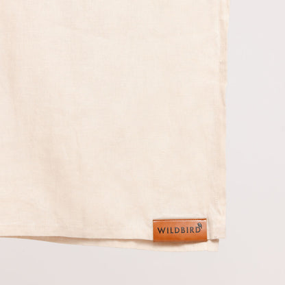 Beige fabric with a brown leather label on a white background