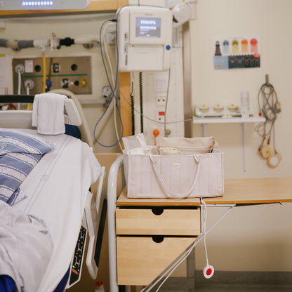 Hospital room with medical equipment and a bag on a table