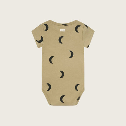 Beige baby onesie with black moon pattern on a white background