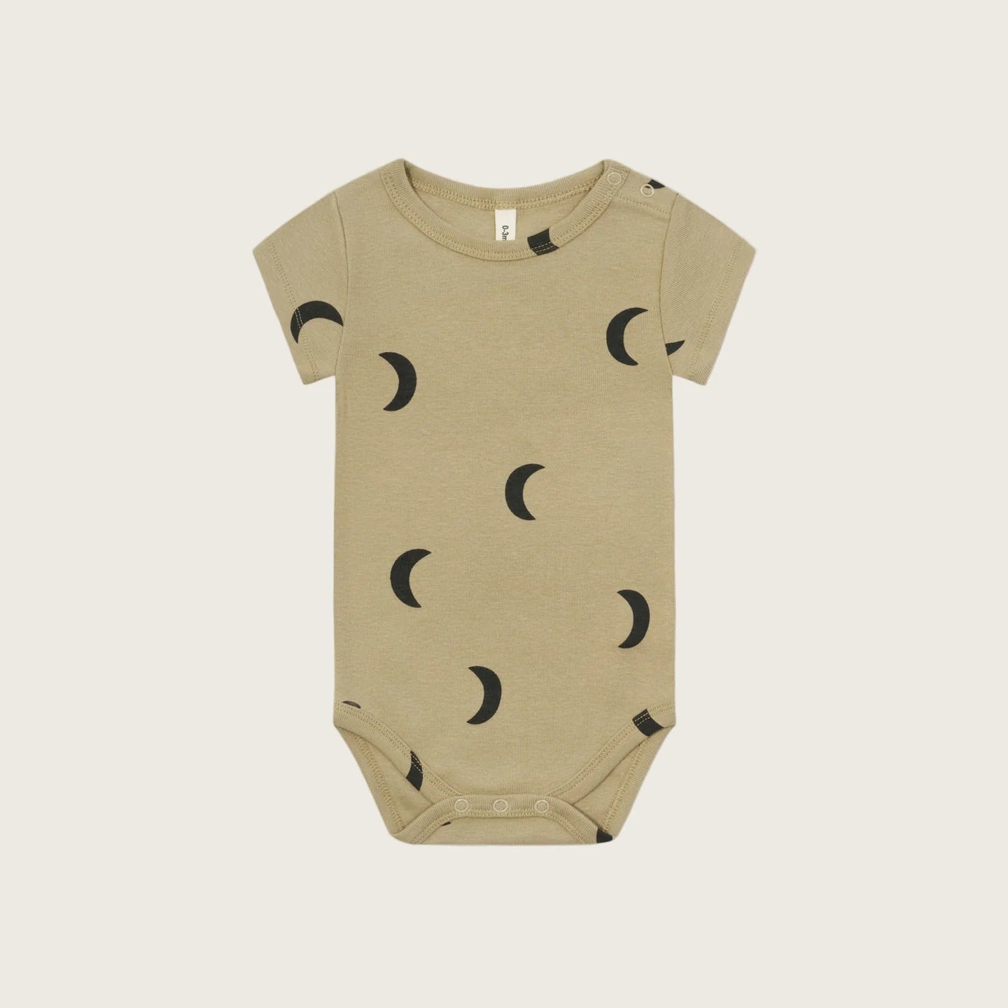 Beige baby onesie with black moon pattern on a white background