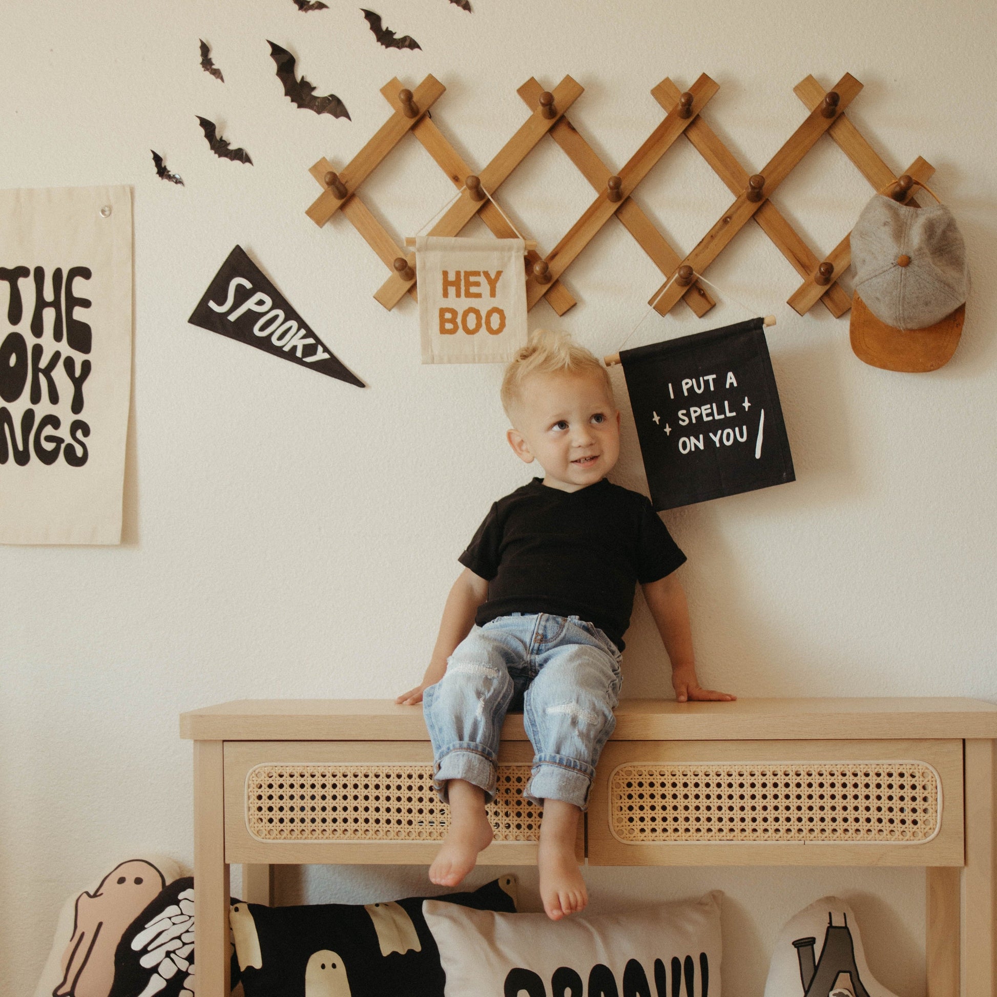 Child sitting on a table with Halloween decorations in the background
