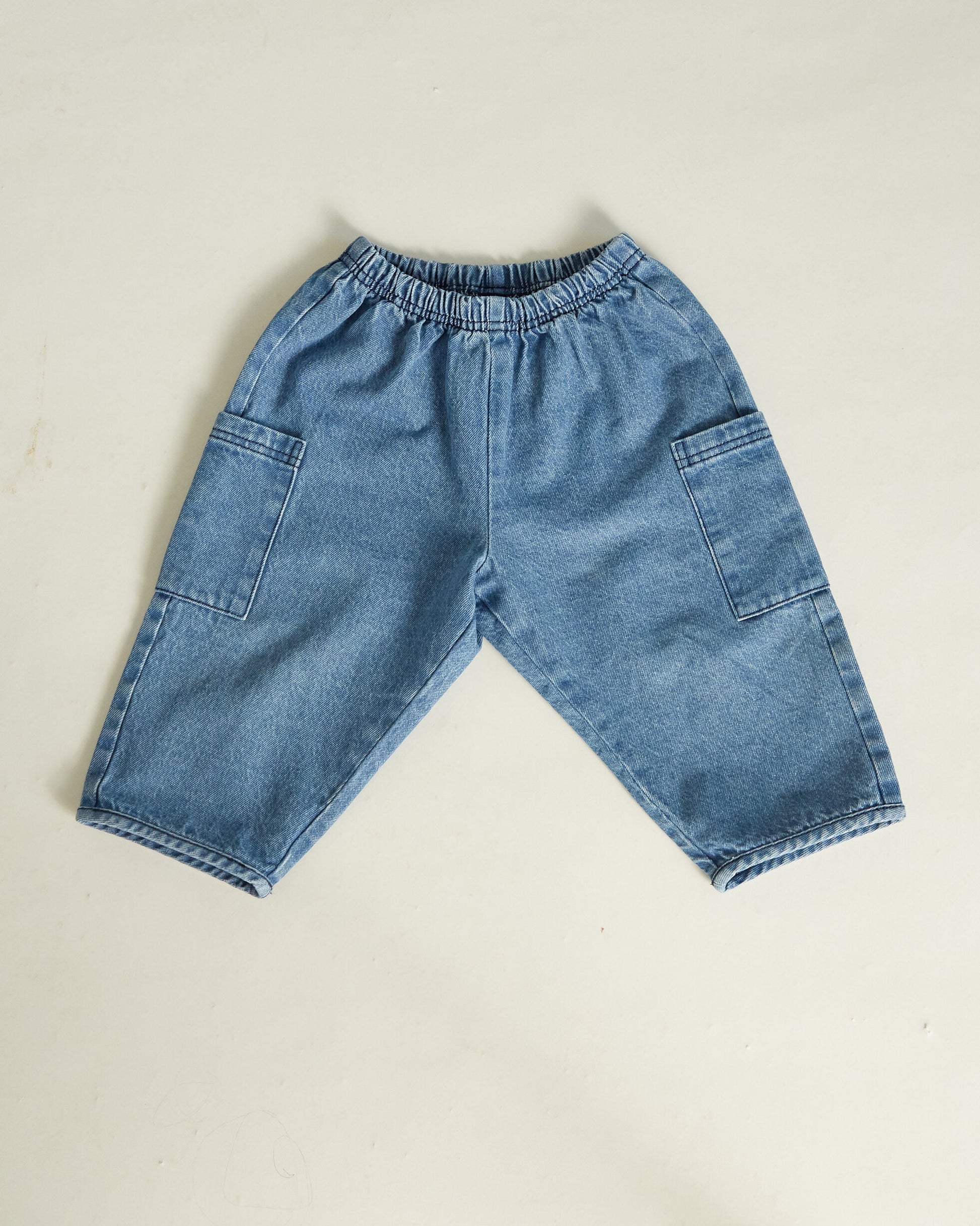 Blue denim shorts on a beige background