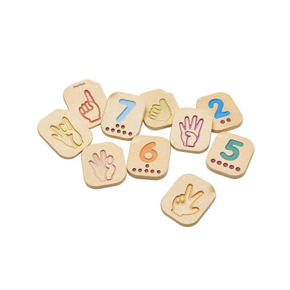 Set of wooden number and hand gesture tiles on a white background