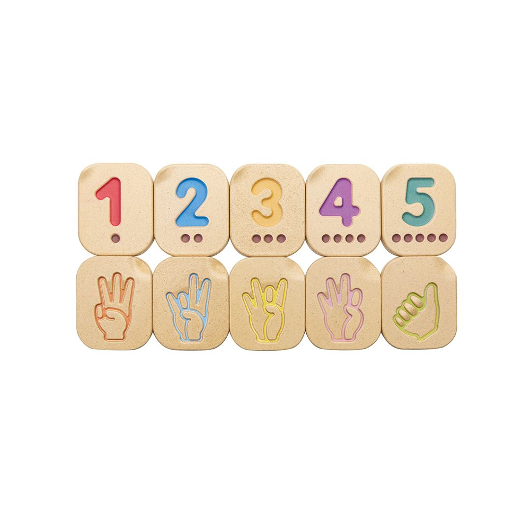 Set of wooden number and sign tiles on a white background