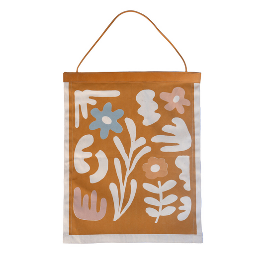 Decorative wall hanging with floral patterns on a brown background