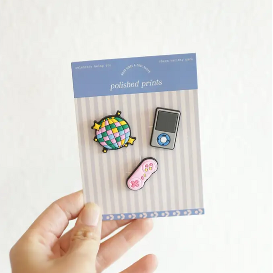 Packaged pins with a hand holding the packaging against a white background