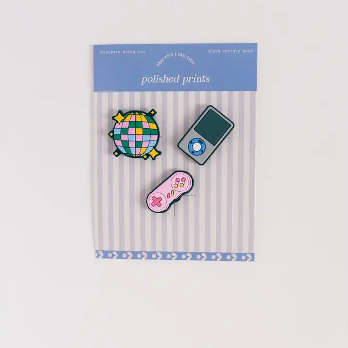Set of colorful pins in packaging with 'polished prints' label on a white background