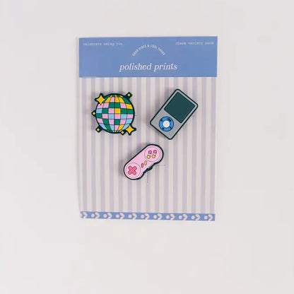Set of colorful pins in packaging with 'polished prints' label on a white background