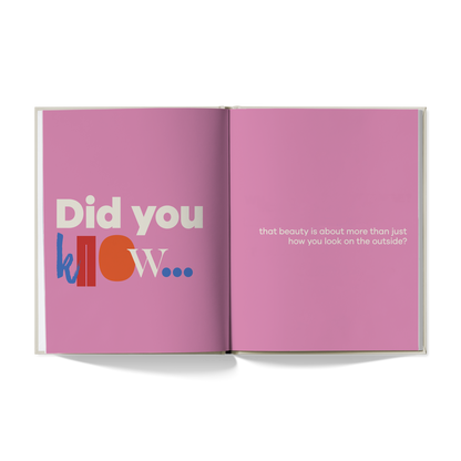 Open book with pink pages displaying text on a white background