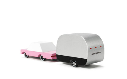 Model of a pink car with a silver trailer on a white background