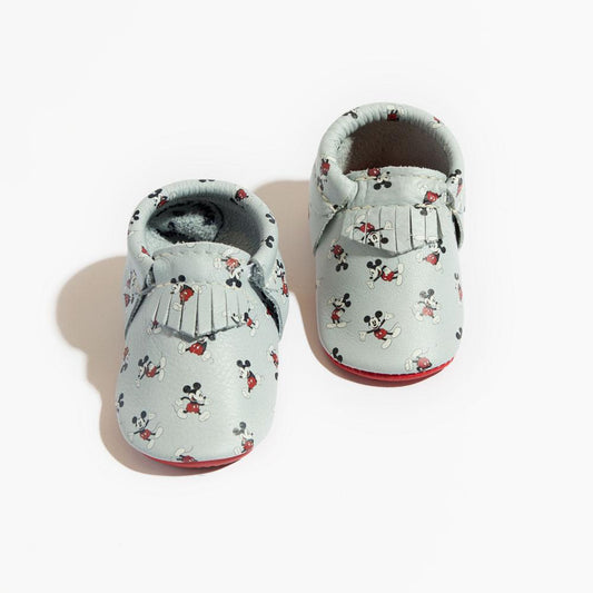 Pair of baby shoes with a floral pattern on a white background