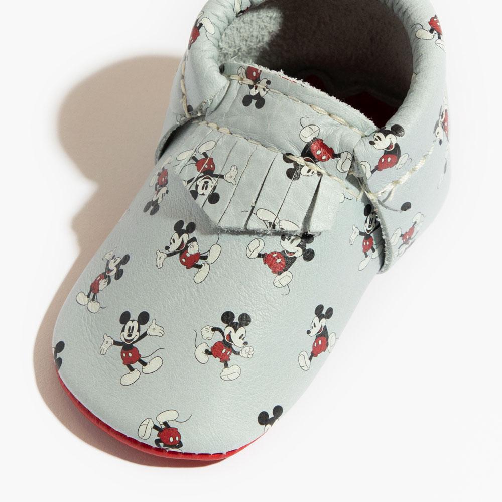 Light blue shoe with Mickey Mouse pattern on a white background
