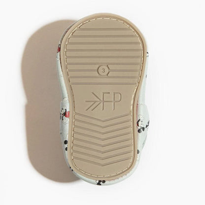 Close-up of a shoe sole with a brand logo on a white background