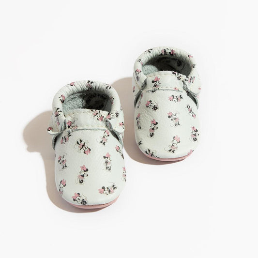 Floral-patterned baby shoes on a white background