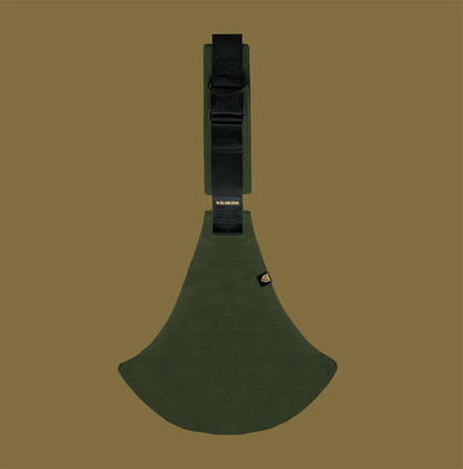 Green toddler carrier on a brown background
