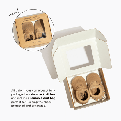 Baby shoes in a durable craft box with a reusable dust bag on a white background.