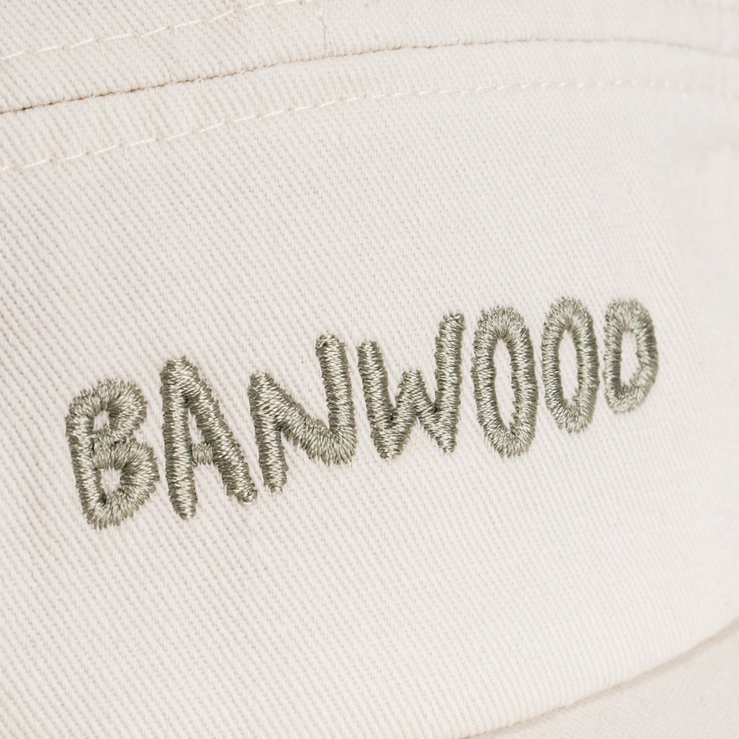 Embroidered text 'BANWOOD' on a light fabric background