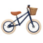 Children's balance bike with a basket on a white background