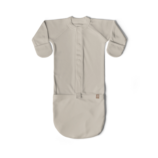 Beige baby sleeping bag with buttons on a white background