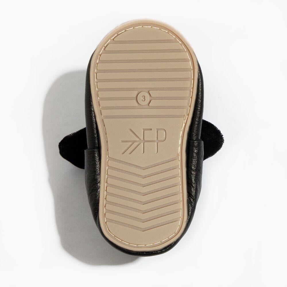 Close-up of a sandal sole with a brand logo on a white background