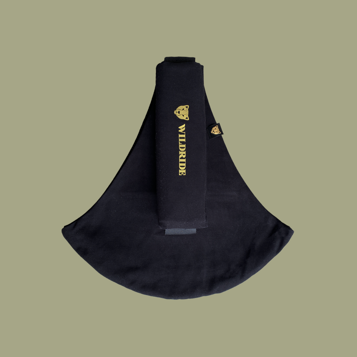 Black sling bag with gold branding on a beige background
