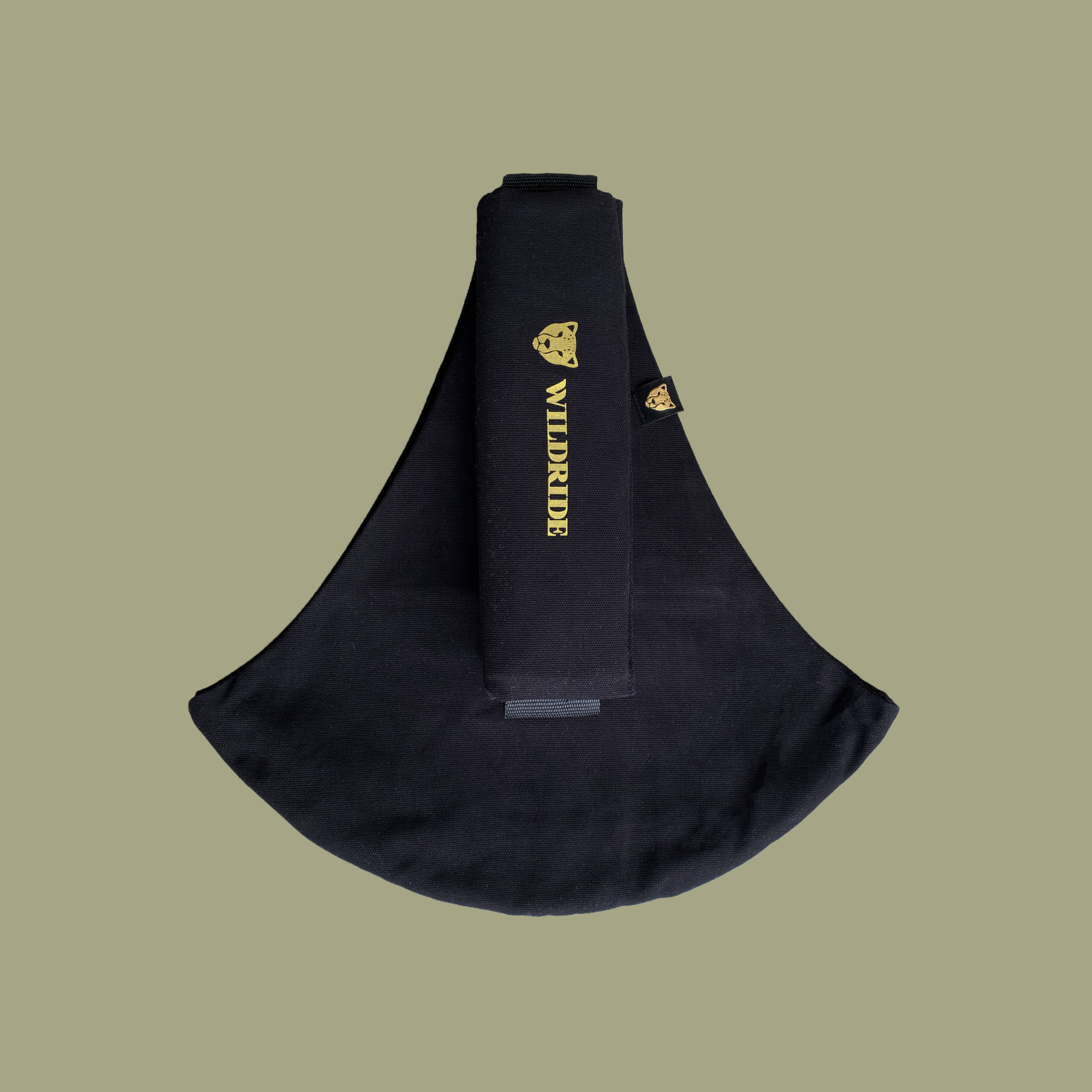 Black sling bag with gold branding on a beige background