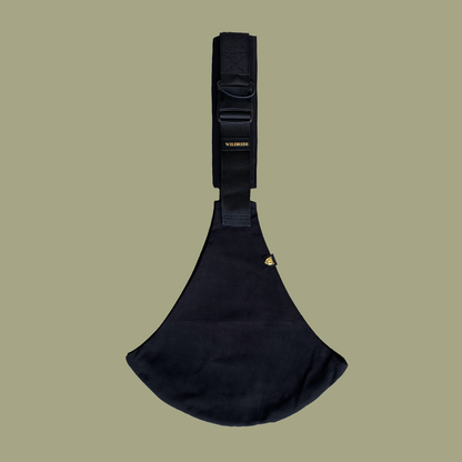 Black toddler carrier with visible branding on a beige background