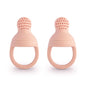 Two pink silicone teething rings on a white background