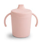 Pink sippy cup with handles on a white background