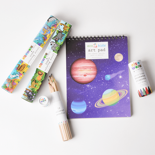 Children's art supplies including a notebook with space-themed design, colored pencils, and markers on a white background.