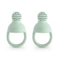 Two mint green silicone teething rings on a white background