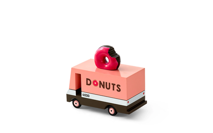 Toy donut truck with a pink box and donut on top against a white background