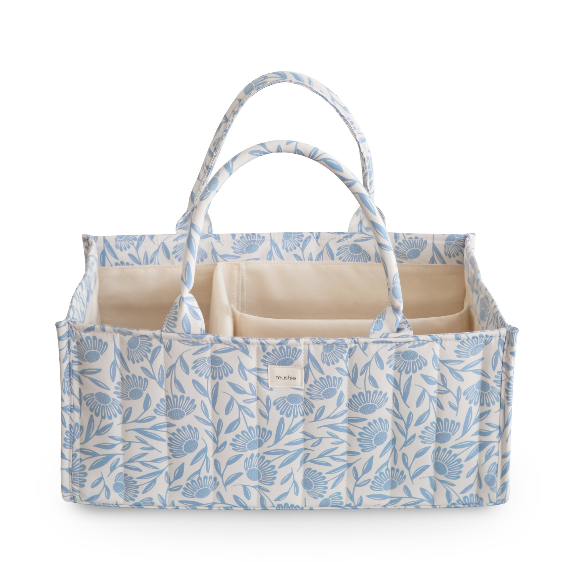 Floral-patterned baby changing bag with beige interior on a white background