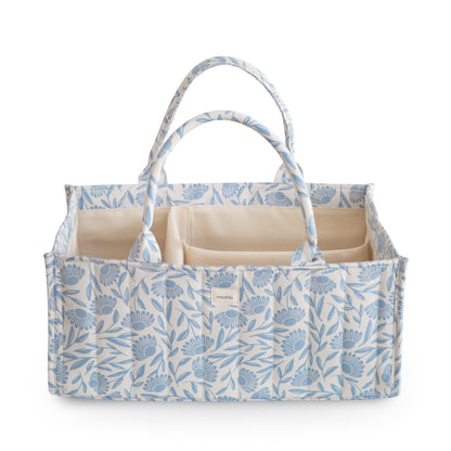 Floral-patterned baby changing bag with beige interior on a white background