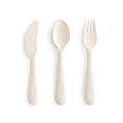 Set of white cutlery including a knife, spoon, and fork on a white background