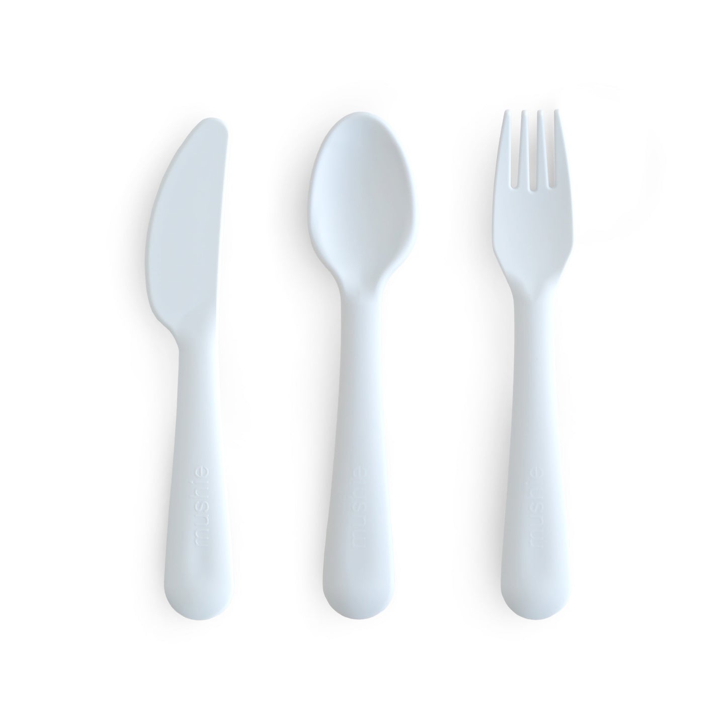 Set of white plastic knife, spoon, and fork on a white background