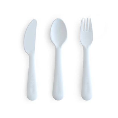 Set of white plastic knife, spoon, and fork on a white background
