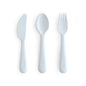 Set of white plastic knife, spoon, and fork on a white background