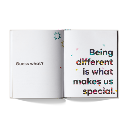 Open book with text 'Guess what? Being different is what makes us special.' on a white background