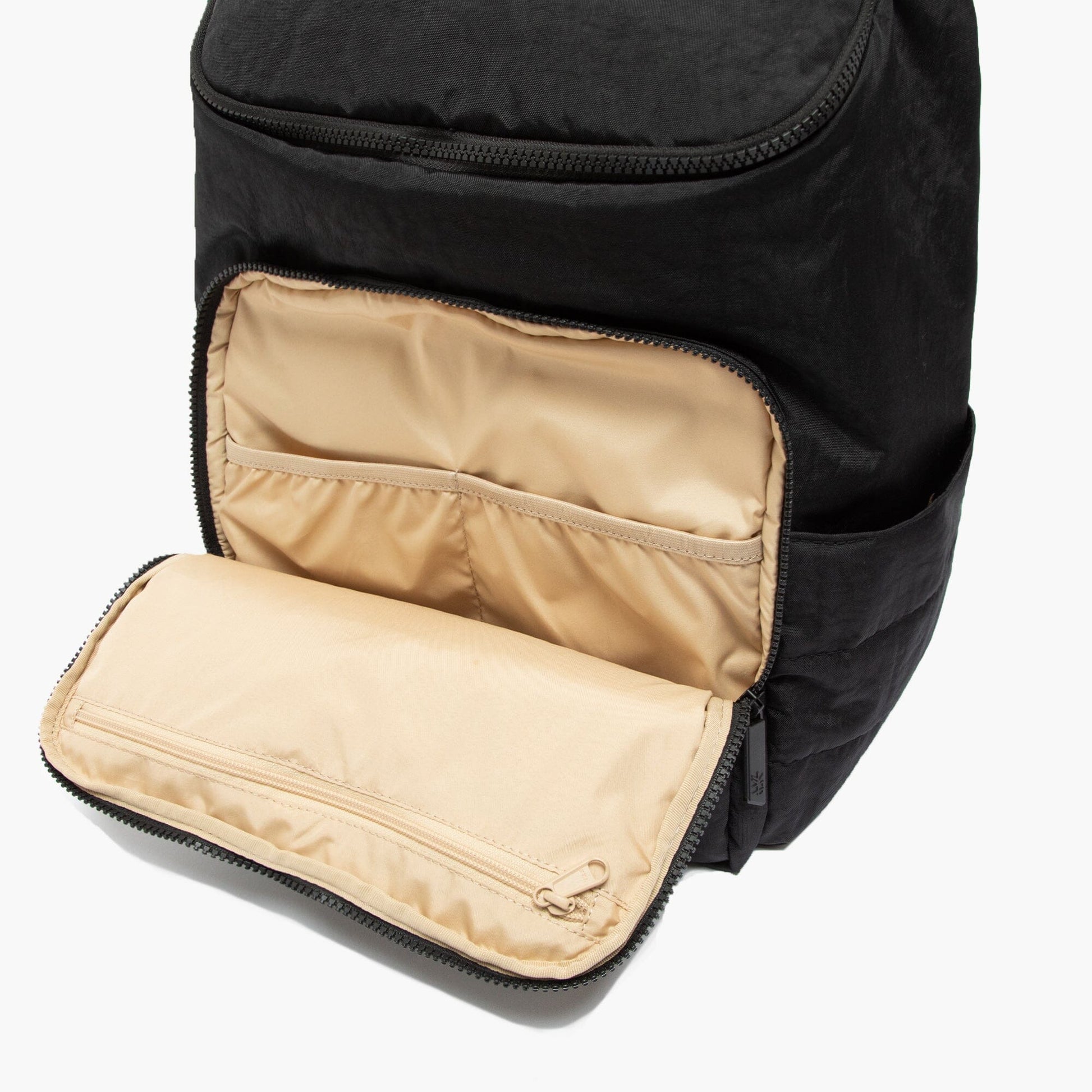 Black backpack with beige interior pocket on a white background