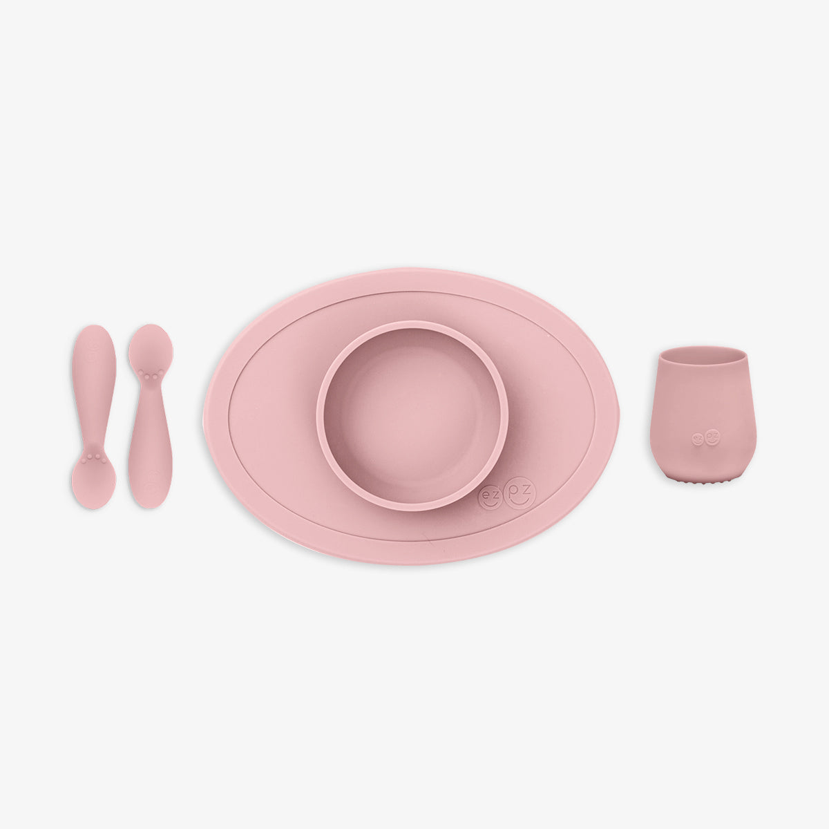 Pink children's dining set including plate, bowl, cup, and utensils on a white background