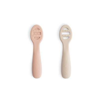 Two baby spoons with silicone handles on a white background