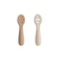 Two beige baby spoons on a white background