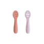 Two baby utensils, one pink and one purple, on a white background.