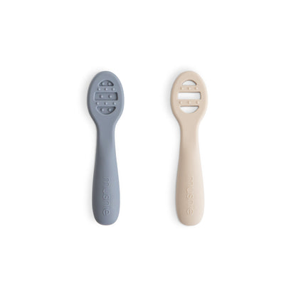 Two baby utensils, one gray and one beige, on a white background
